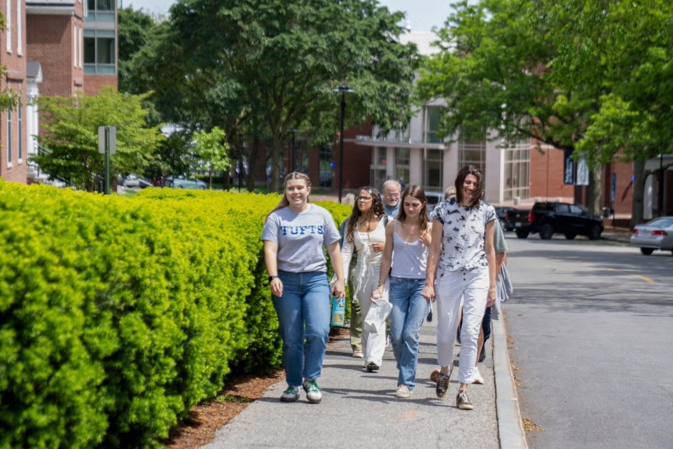 A Tufts admissions tour group walks on campus in May 2025