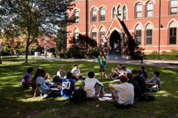 A class meets outdoors on the Academic Quad.
